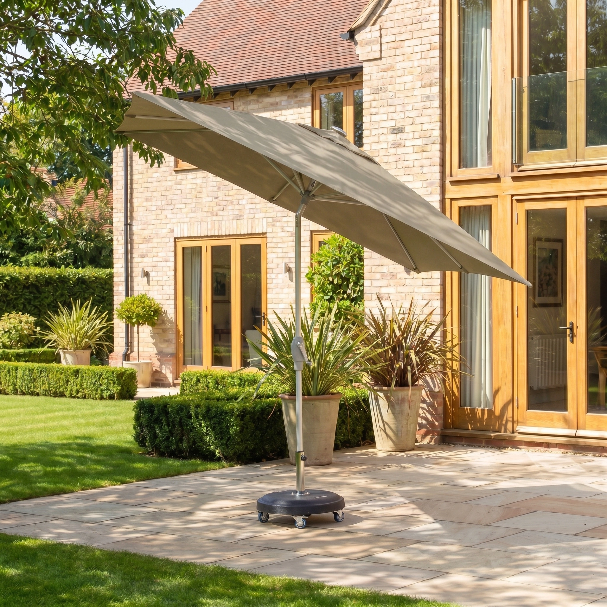 The Zelos 2.5m Square Parasol with LED Lighting in Taupe offers stylish shade and comfort, ideal for outdoor spaces like a stone terrace or patio outside your home.