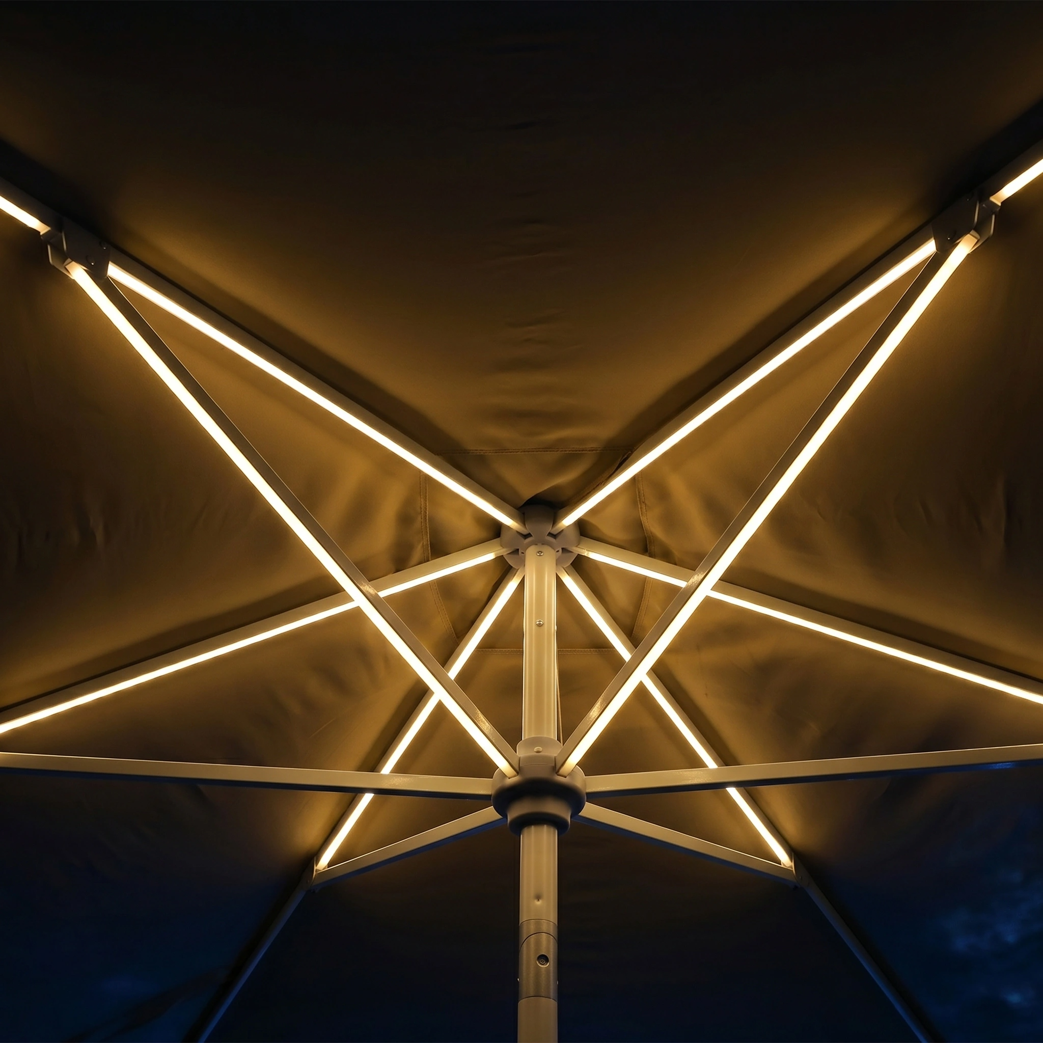 View from below of the Zelos 3m x 2m Rectangular Parasol with LED Lighting in Taupe at night, its ribs aglow—an elegant garden parasol ideal for evening gatherings.