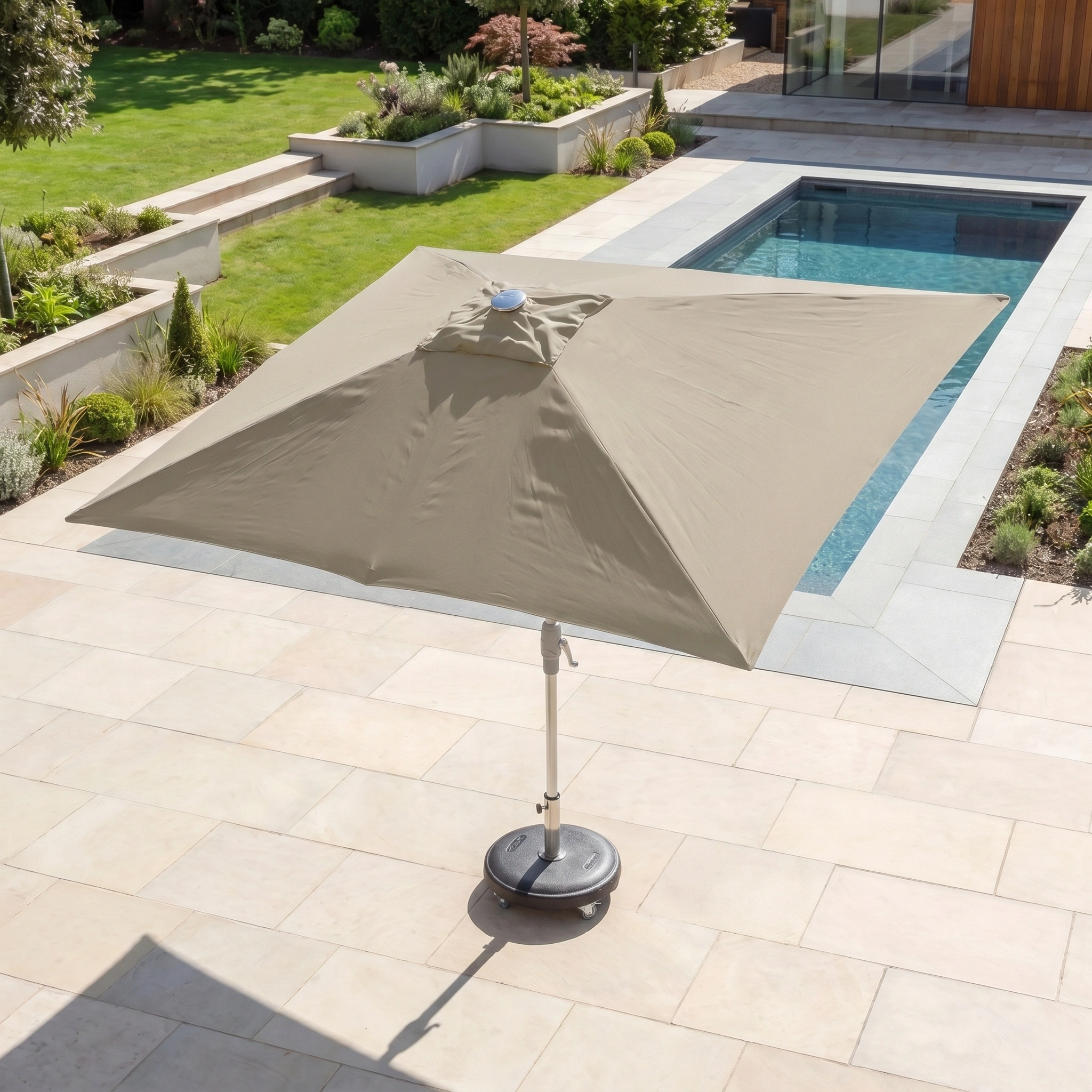 The Zelos 3m x 2m Rectangular Parasol with LED Lighting in Taupe provides stylish, functional shade for your outdoor pool or garden area, enhancing comfort and ambiance by day or night.