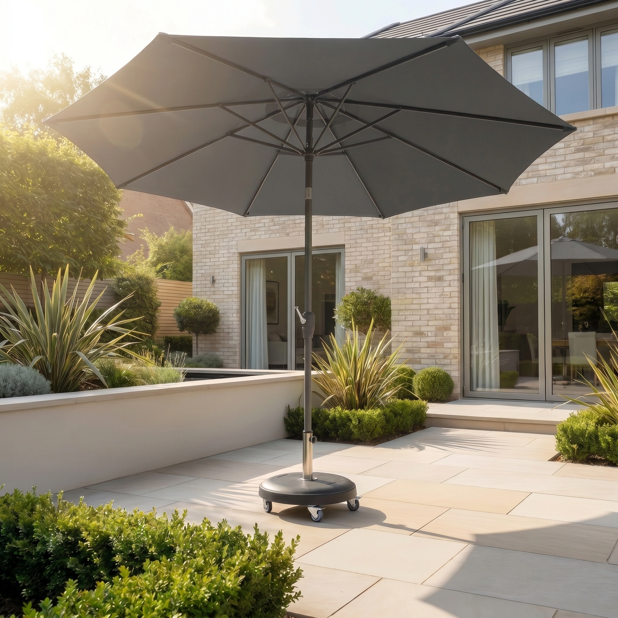 The Zelos 3m Round Parasol with LED Lighting in Grey offers UV-protected shade on a modern tiled terrace outside a contemporary house.