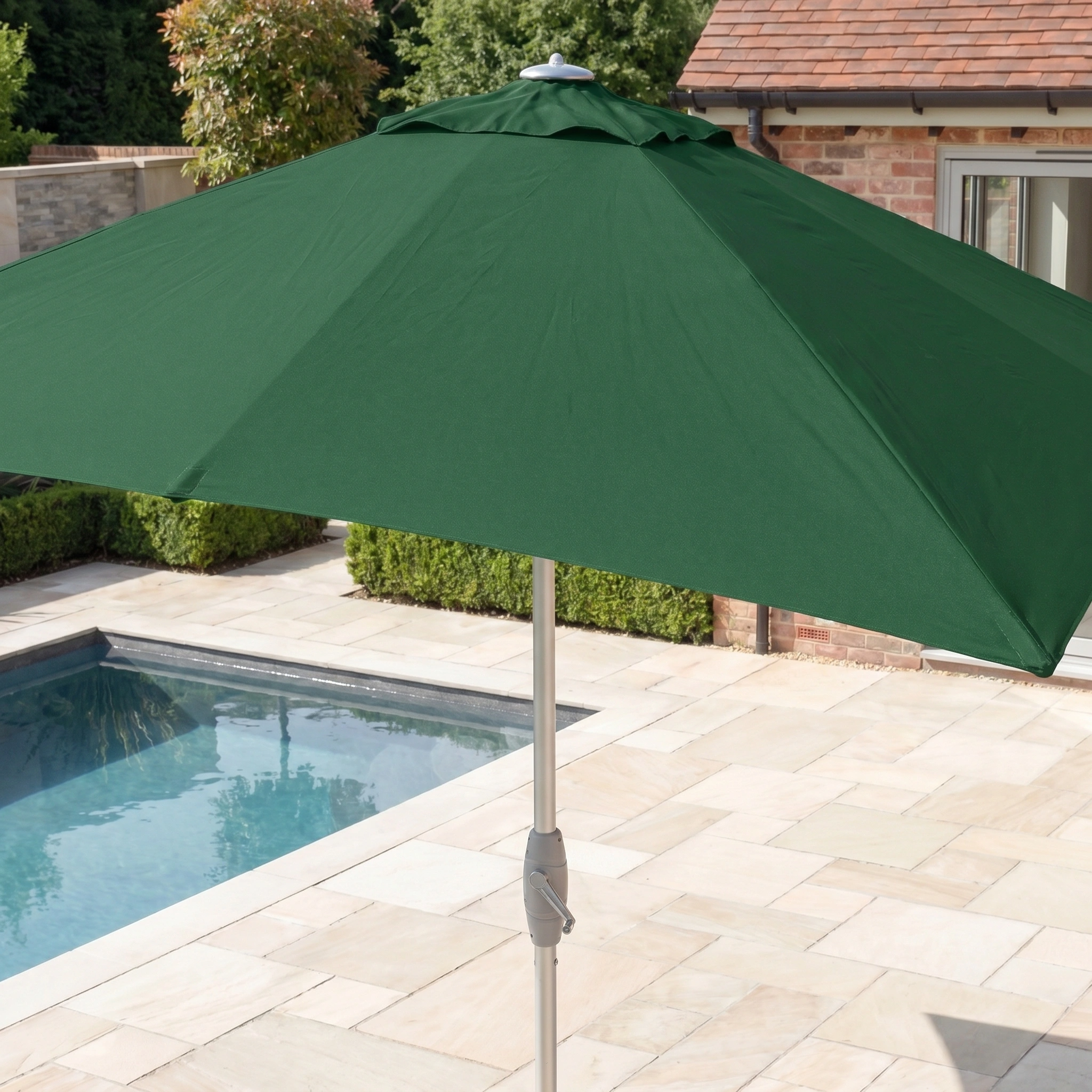 The Zelos 3m x 2m Rectangular Parasol with LED Lighting in Green shades a tiled area by the pool, providing stylish UV protection in your sunny backyard.
