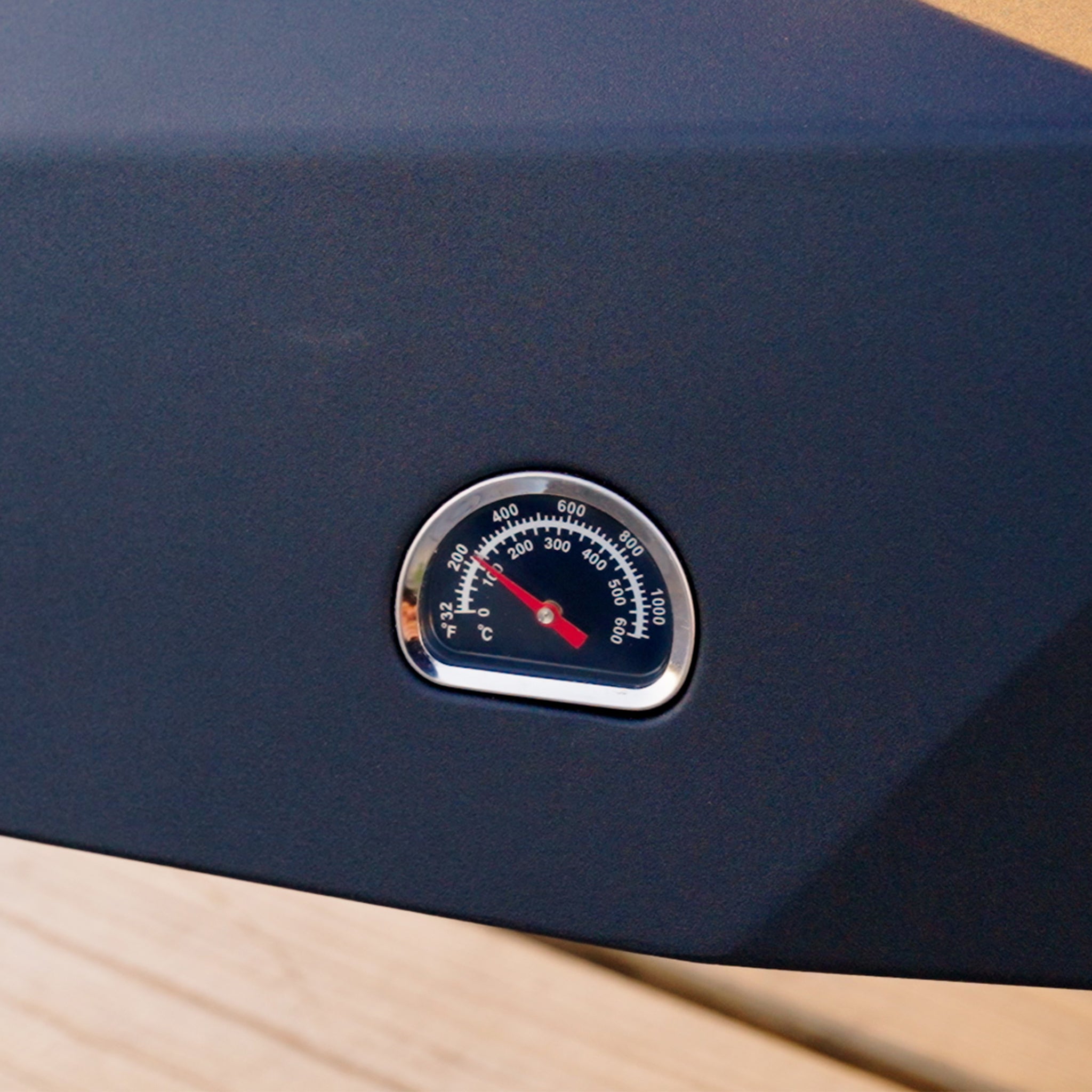 Close-up of a black temperature gauge on the Juno Pro 16" Gas Pizza Oven, showing a reading of approximately 400 degrees Fahrenheit, perfect for achieving that ideal 60-second stone-baked pizza.
