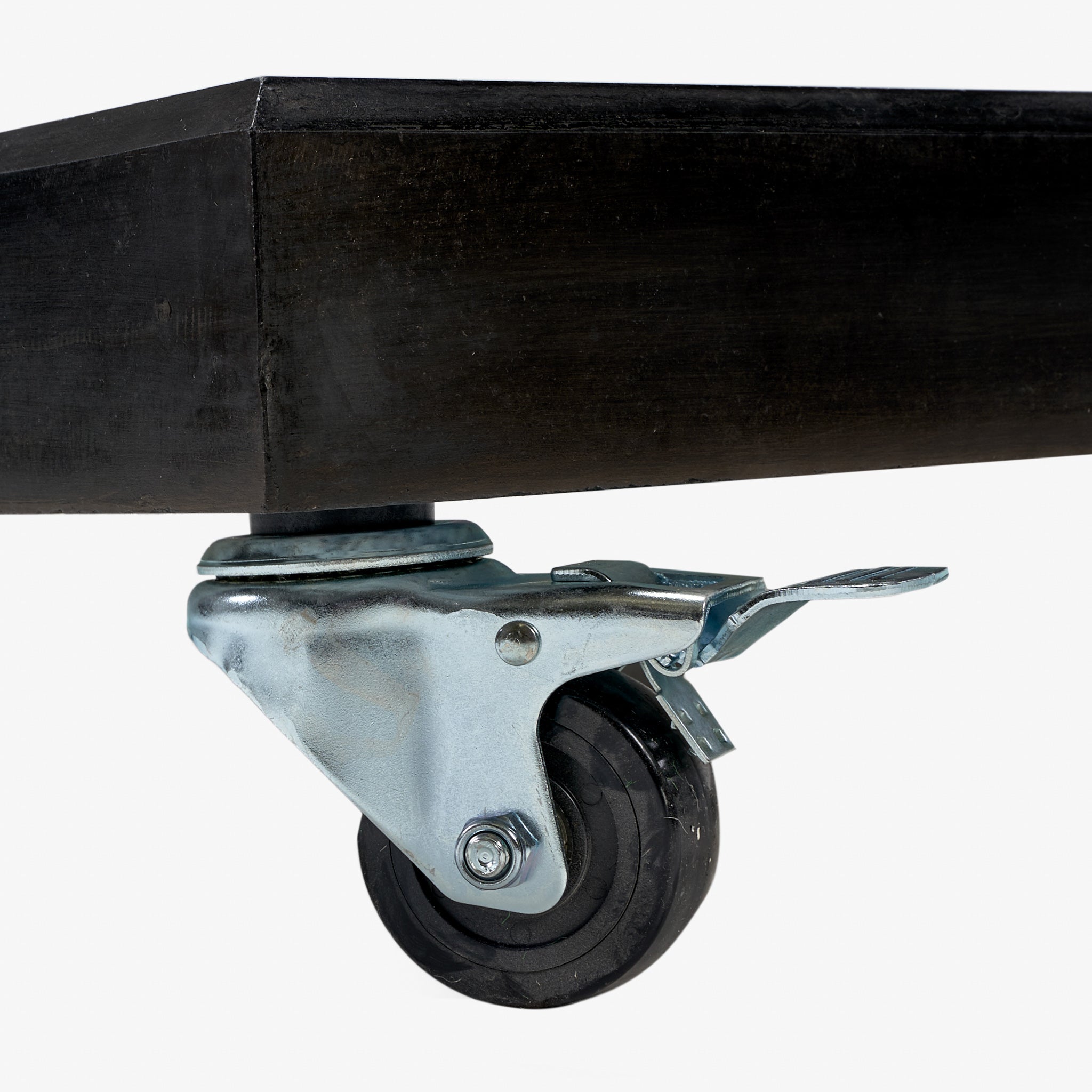 Close-up of the Pacific Lifestyle - Modena Parasol Base, showcasing a swiveling caster wheel with brake and adjustable turn lock for enhanced stability on its polished black granite base.