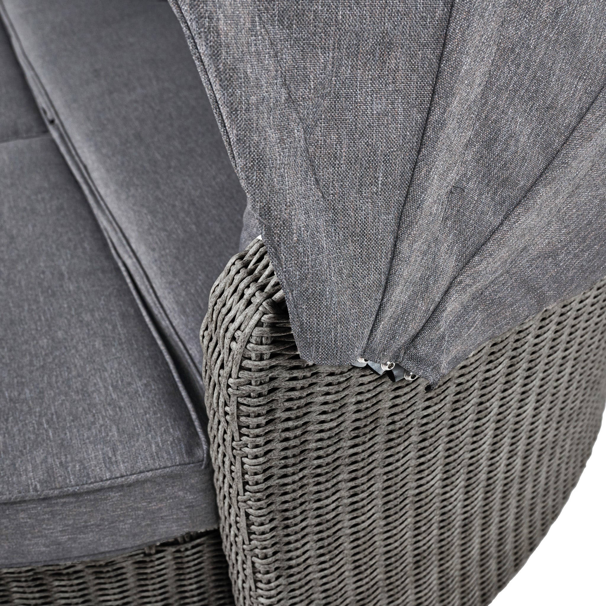 Close-up of a weatherproof slate grey woven outdoor chair with gray cushions and a partially visible fabric canopy, reminiscent of the Pacific Lifestyle - Bermuda Daybed's elegant, space-saving design.