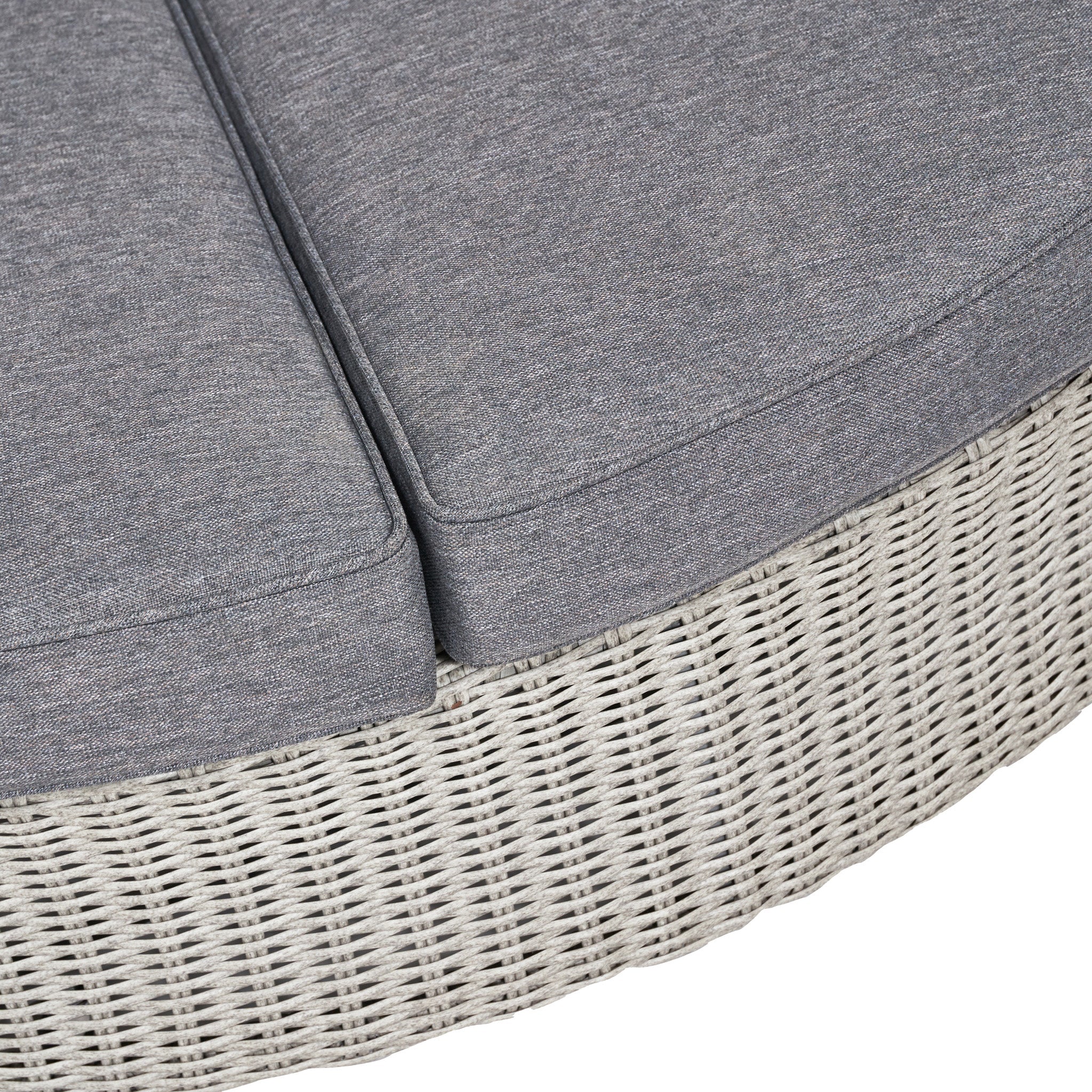 Close-up of a circular wicker ottoman with gray cushions, highlighting its woven texture and seamless design, resembling the Pacific Lifestyle Bermuda Daybed in Stone Grey.