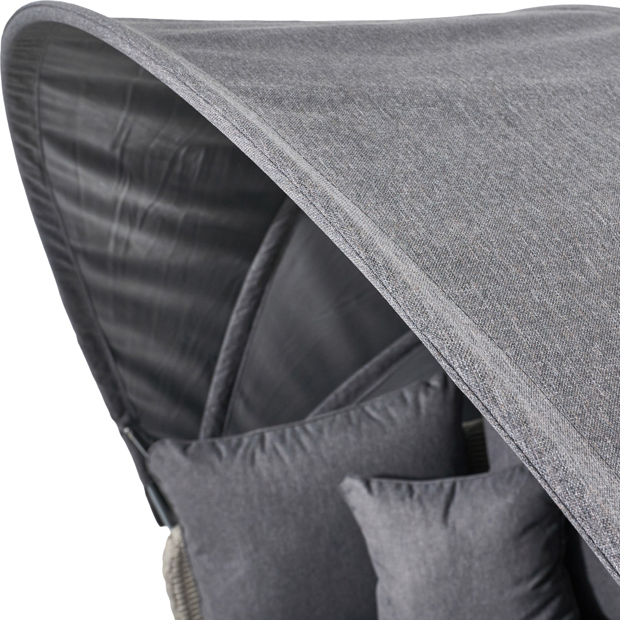 Close-up of a stone grey woven fabric canopy and matching cushions highlighting the durable charm of the Pacific Lifestyle Bermuda Daybed, crafted from weatherproof material.