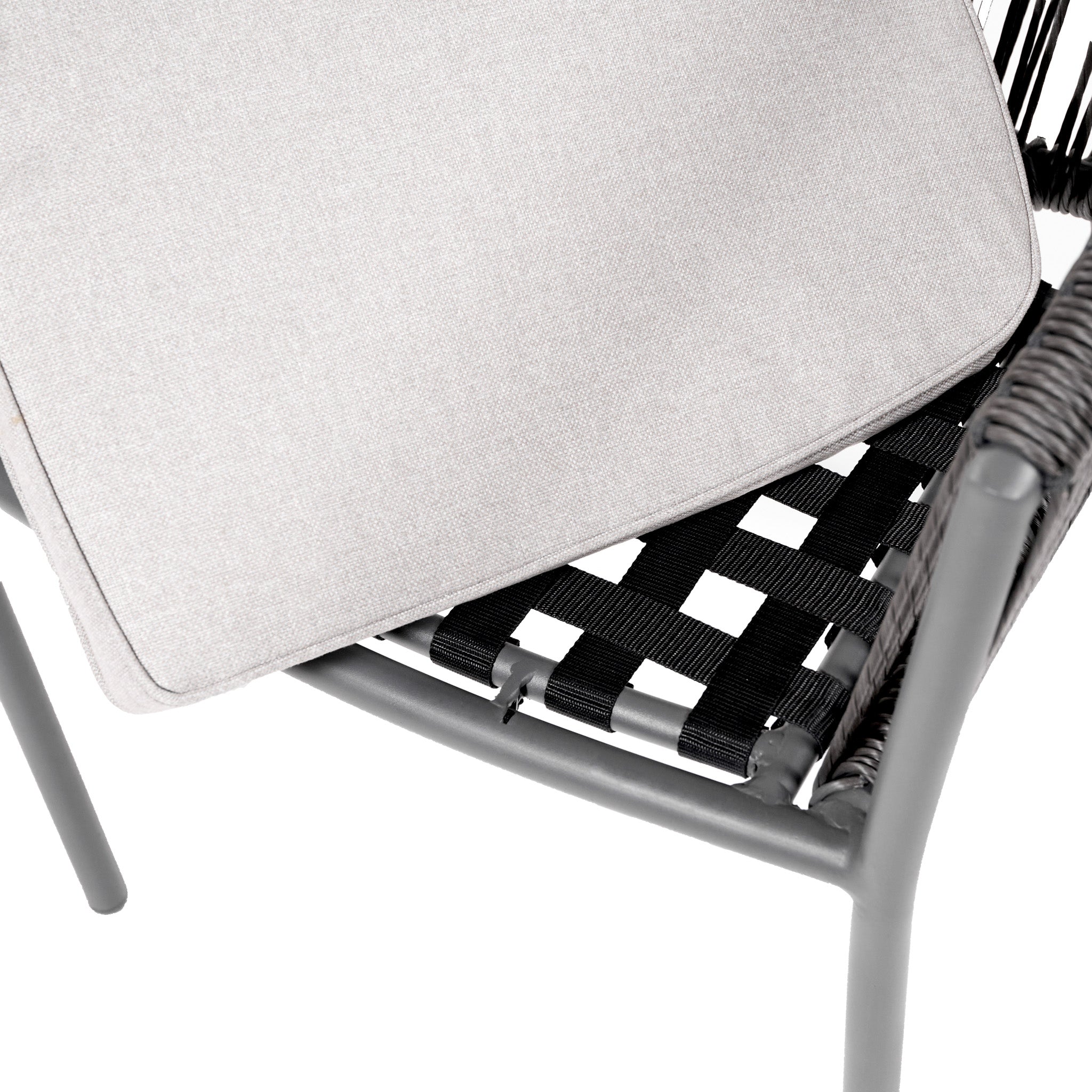 Close-up of a woven chair with black straps and a light gray seat cushion, perfectly complemented by the Pacific Lifestyle - Reims Dining Set in Grey for a contemporary dining experience.