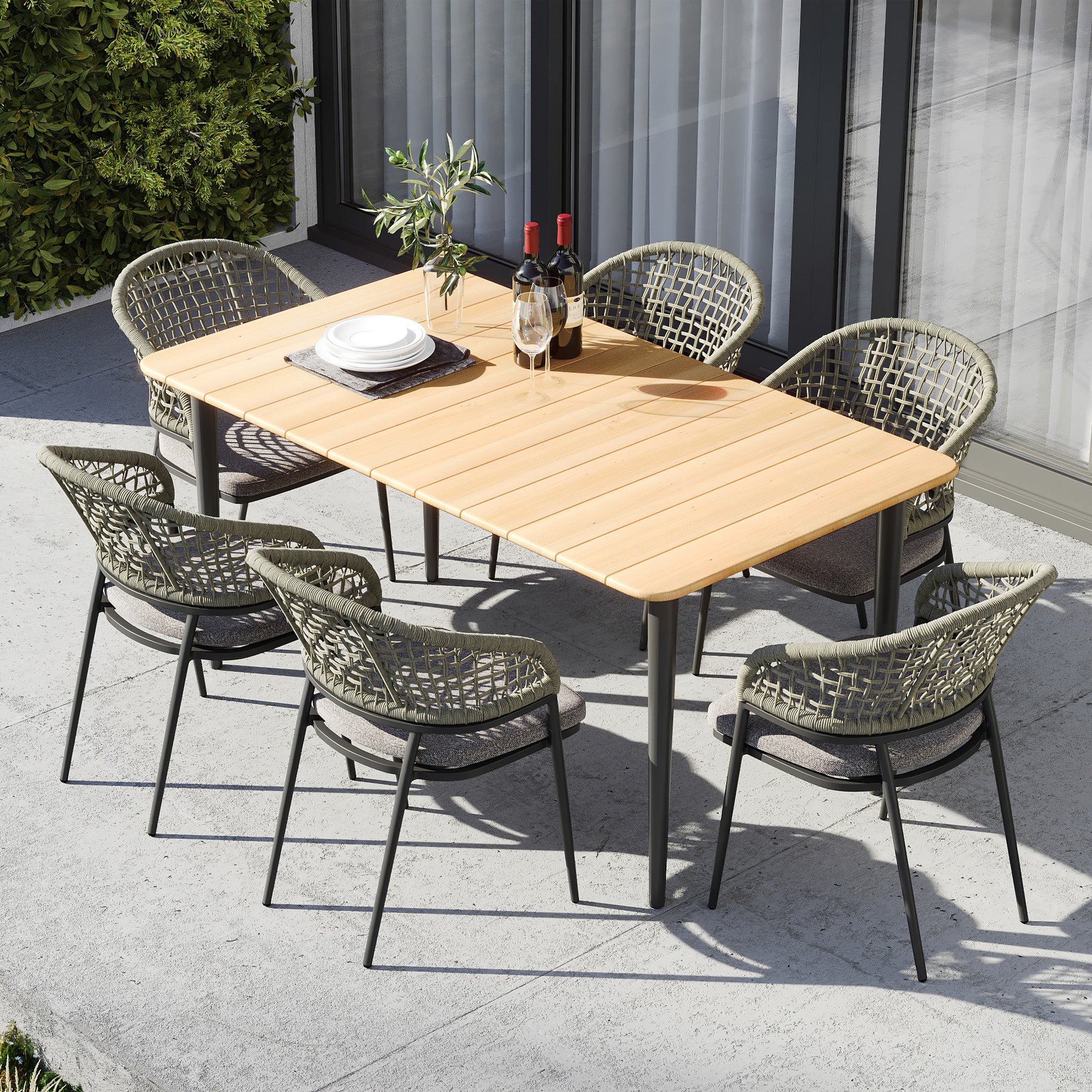 The Kalama 6 Seat Rectangular Dining Set in Olive Green features a weather-proof aluminium teak table and six woven chairs, perfect for outdoor dining with plates, cutlery, and wine bottles.