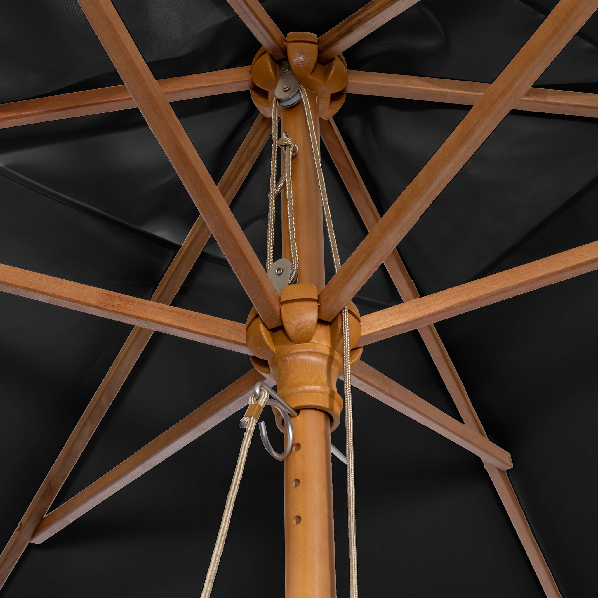 View from beneath of a Kratos 3m x 2m Rectangular Wooden Parasol in Black frame with crisscrossing supports and a winding mechanism, providing UV protection against the dark canopy.