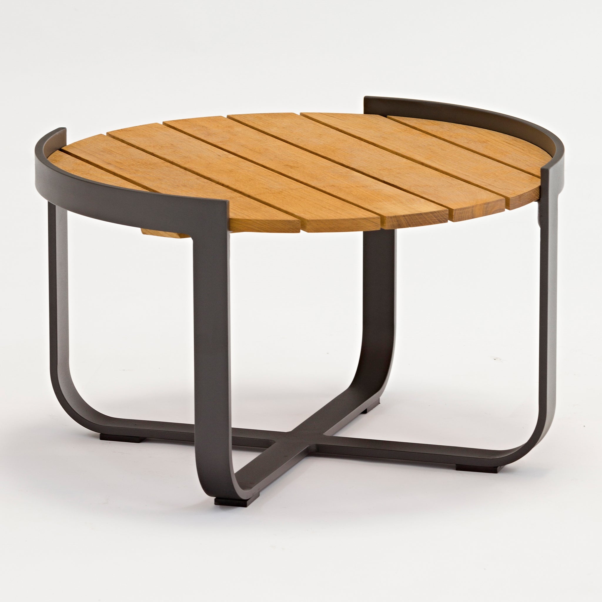 The Bloom Coffee Table with Teak Top in Charcoal is an exquisite piece of outdoor furniture, featuring a round teak top with a slatted design and a gracefully curved metal frame and legs on a white background.