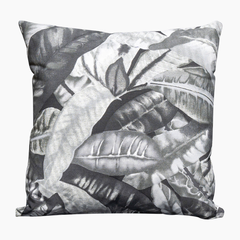 The Acrisol Amazonia Gris Medium Scatter Cushion, measuring 45cm x 45cm, features a black and white tropical leaf pattern on a white background, making it an ideal choice for outdoor scatter cushions to complement your outdoor furniture accessories.