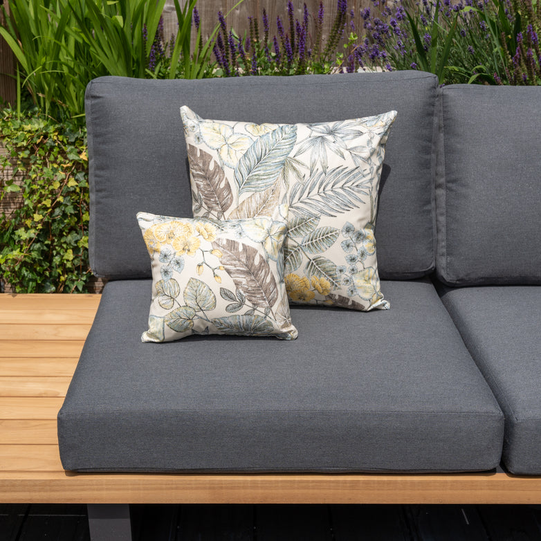 Enhance your garden with our outdoor patio sofa featuring dark gray, solution-dyed acrylic cushions and two floral-patterned Acrisol Bouquet Neutrals scatter cushions, including one large and one small. Perfect for personalized outdoor decor.