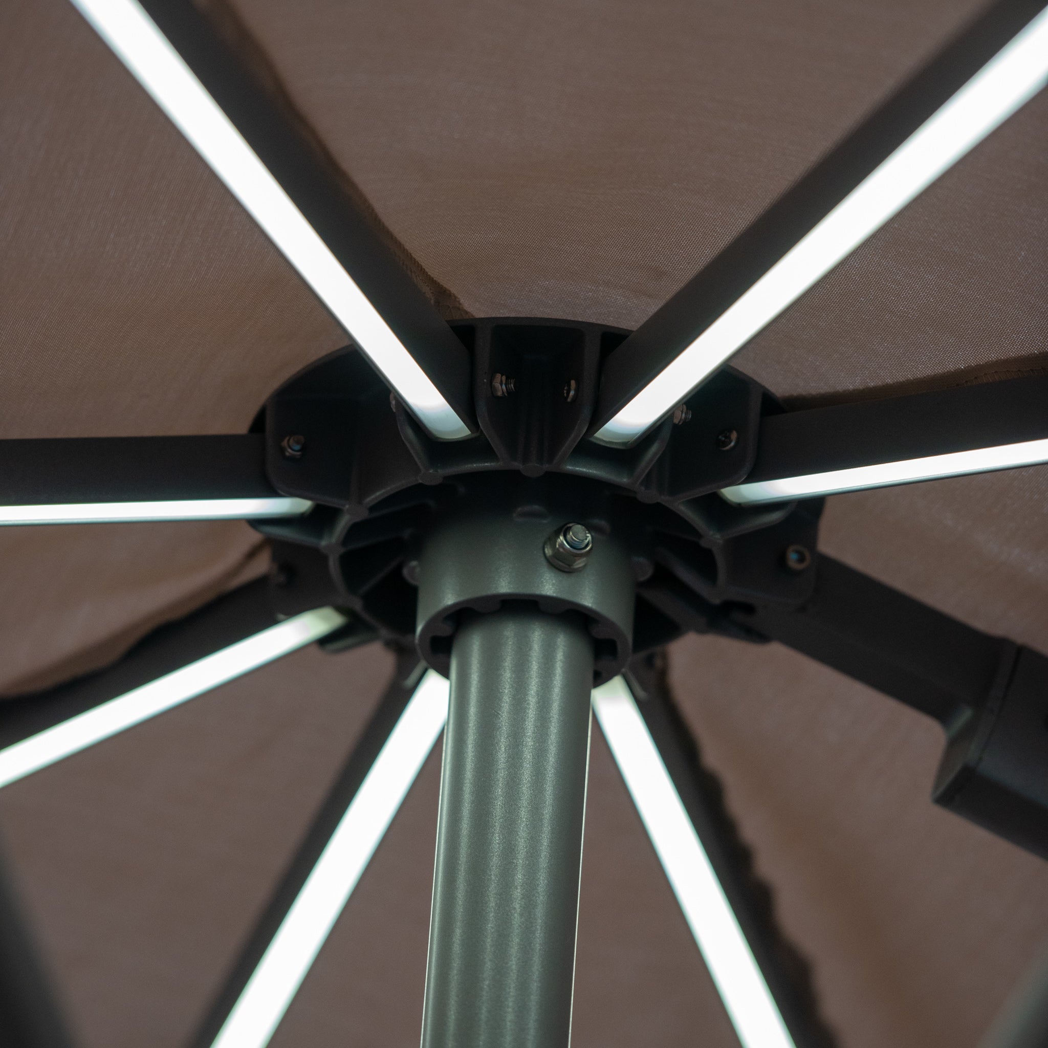 Close-up of the underside of the Pallas 4m x 3m Rectangular Cantilever Parasol with illuminated LED strips along each of its ribs in Beige.