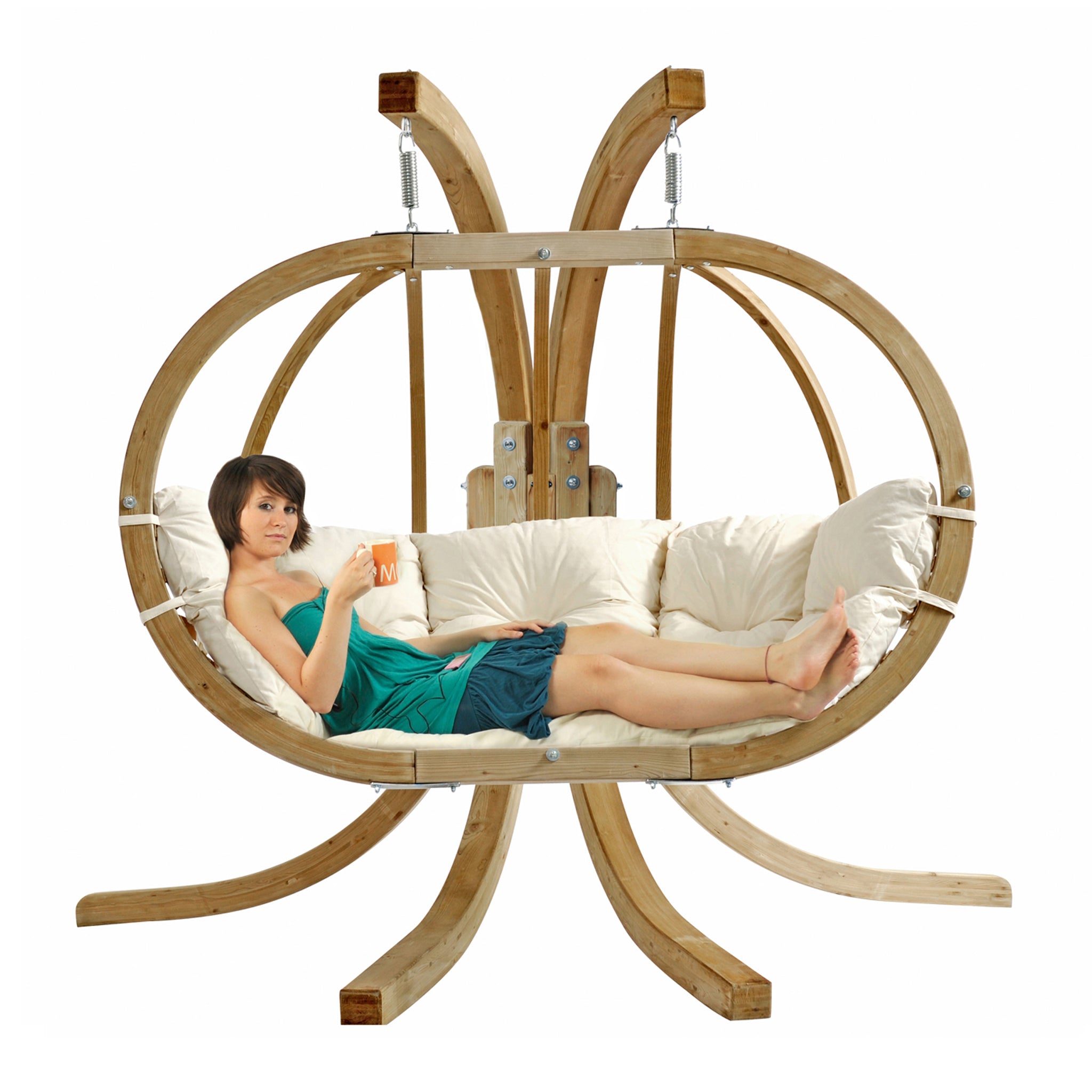 A woman relaxes with a cup and a book in the unique Globo Royal Double Seater Hanging Chair in Natura, featuring a cushioned seat and perfect for outdoor use. Crafted from weatherproof spruce wood, it provides ultimate comfort and durability.