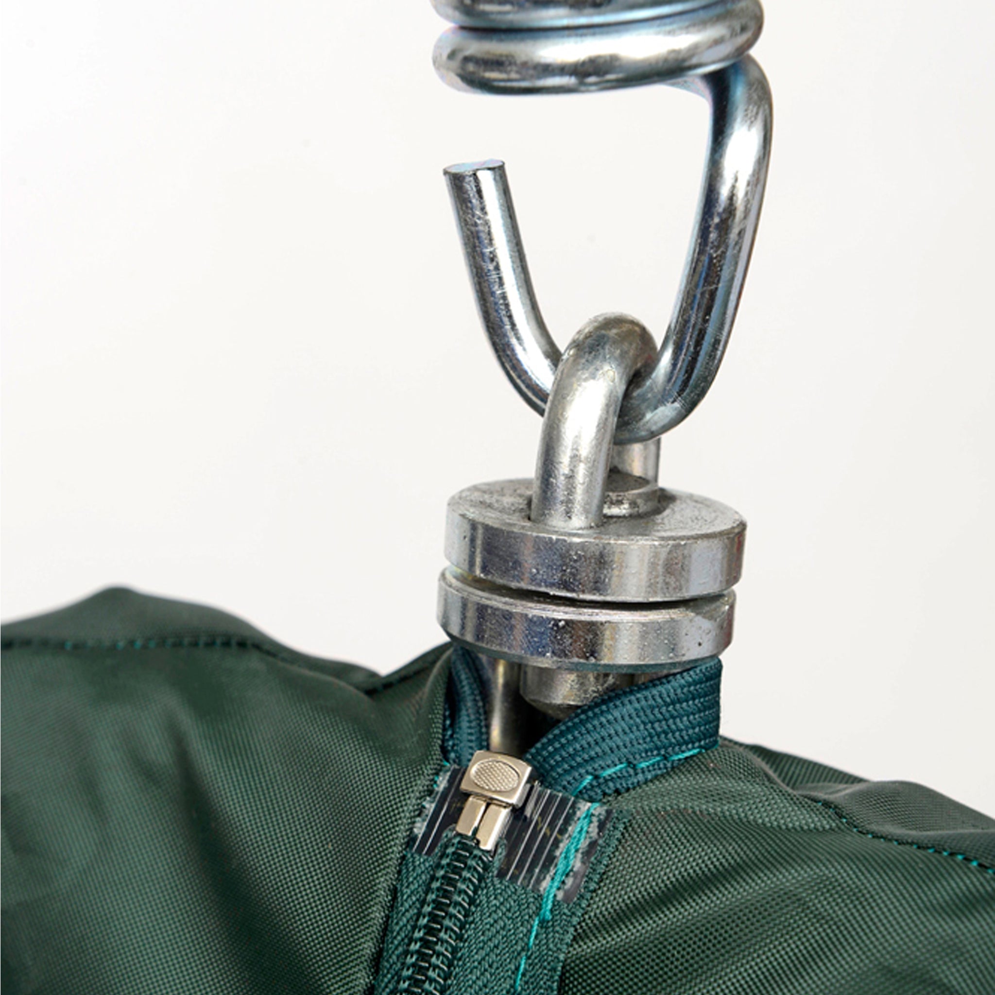 Close-up of a green zipper attached to a metallic hook and suspension system on the Globo Single Seater Rain Cover.