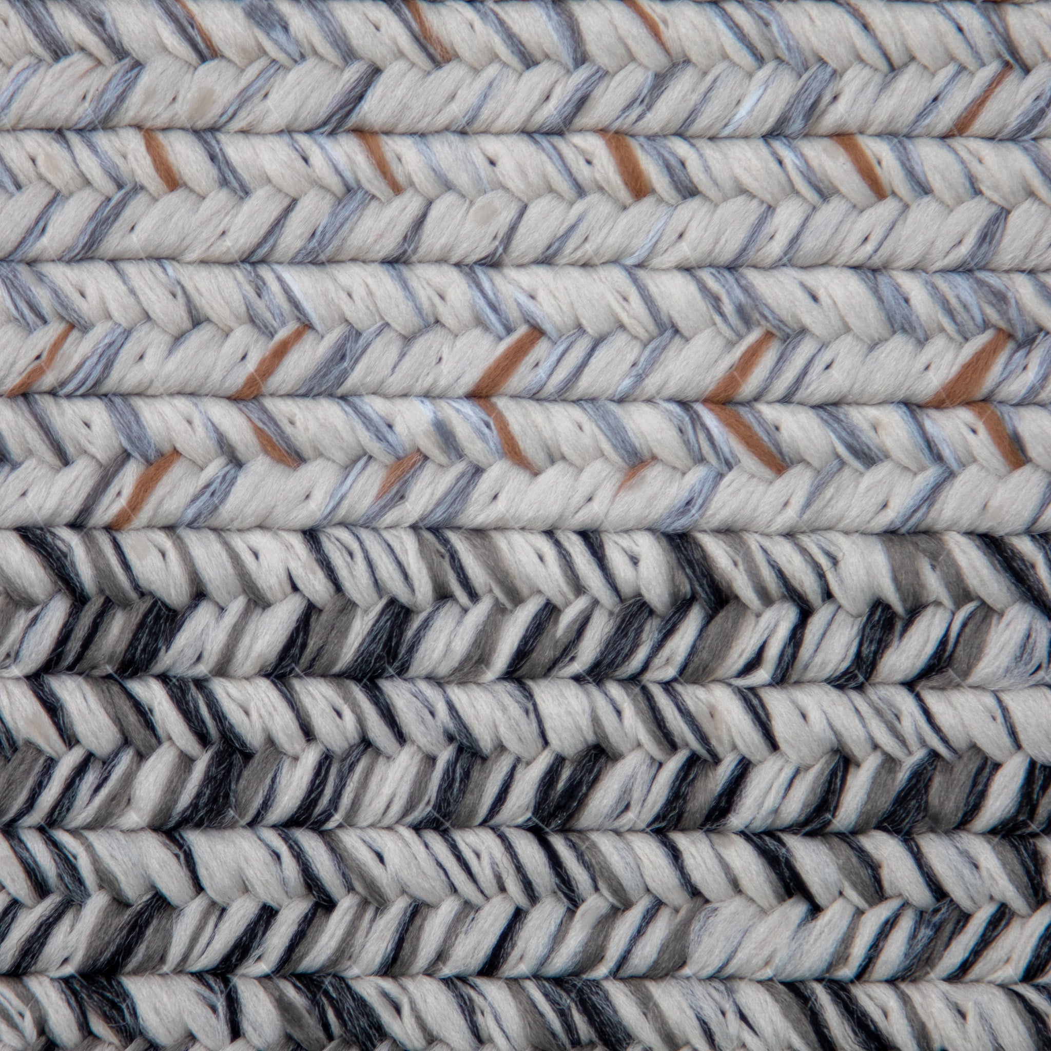 Close-up of the Hades 290cm x 190cm Weatherproof Indoor and Outdoor Rug in Cobble Grey, showcasing its cobble grey, white, and brown fibers intricately woven in parallel rows. The rug is also UV resistant.
