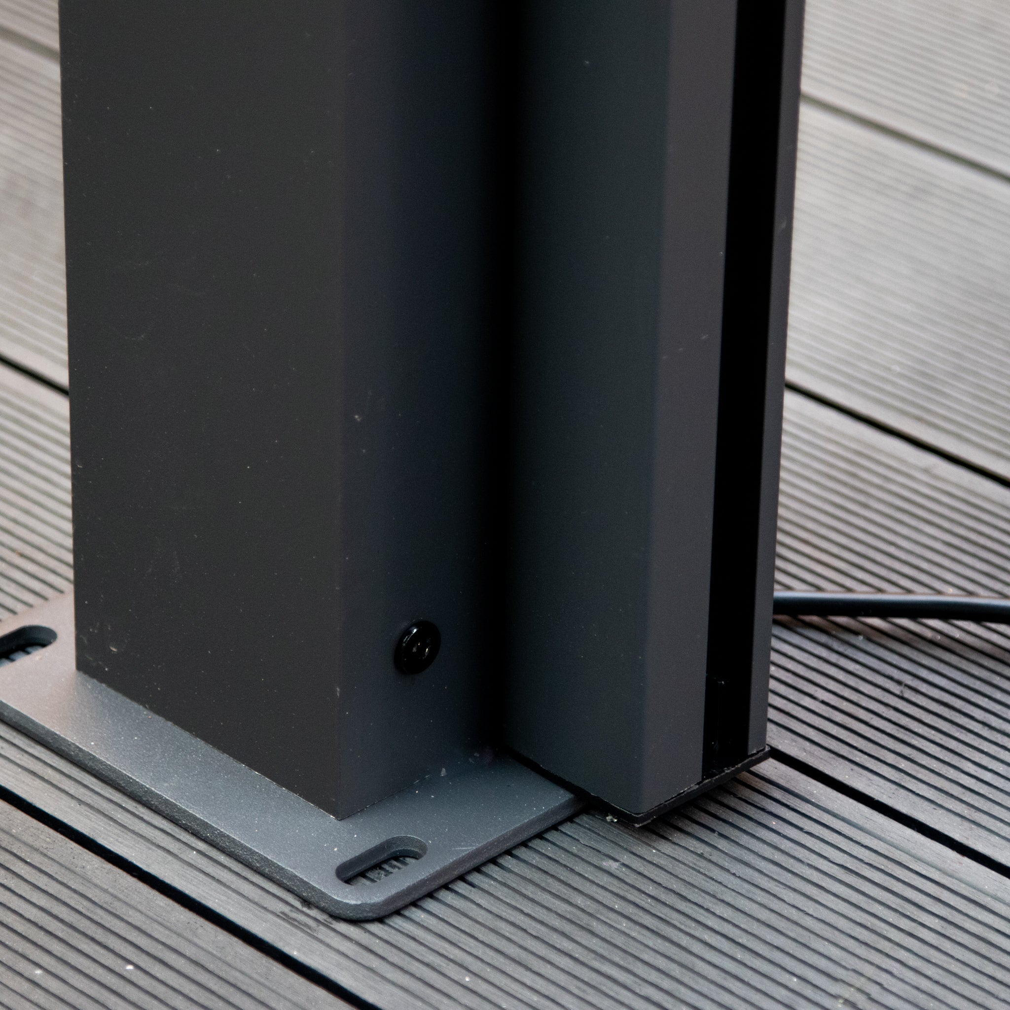 The PergoSTET Plus 3m x 4m Rectangular Pergola, featuring a black metal support beam with screw attachment on grooved decking and a visible black cable, adds contemporary elegance with its sleek design, 3 drop sides, and LED lighting to enhance outdoor spaces.