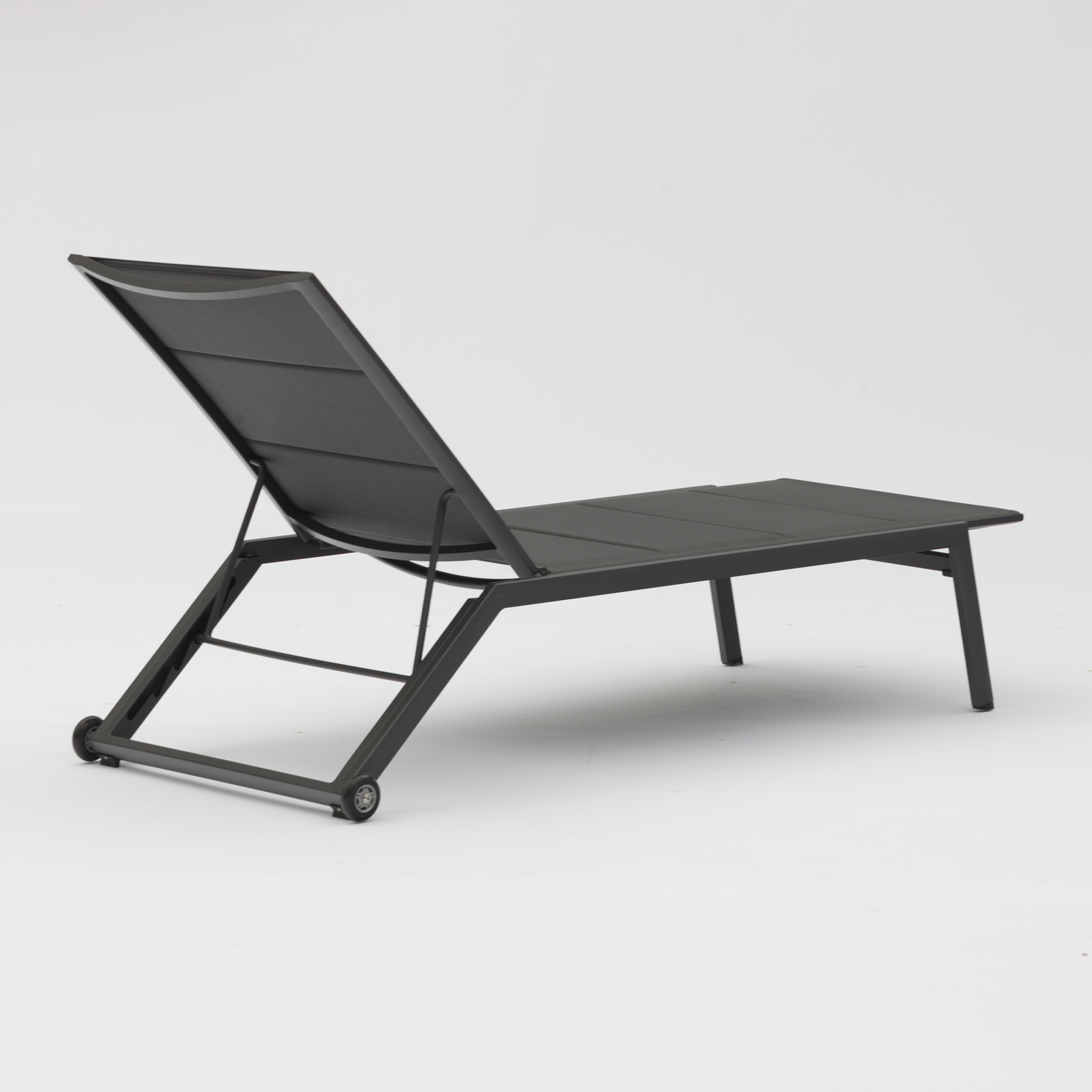 A sleek Monaco Padded Sunlounger in Charcoal with tear-resistant fabric, adjustable backrest, and wheels on the rear legs against a plain white background.