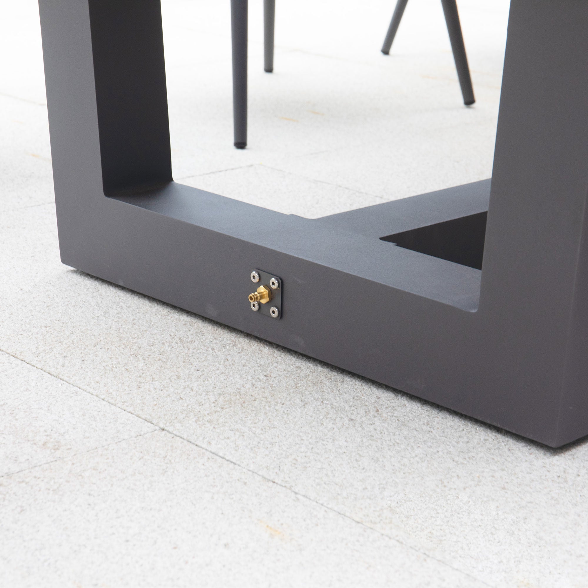 Close-up of the base of a rectangular metal frame, part of the Monterrey 8 Seat Rope Rectangular Teak Firepit Dining Set in Grey from Harbour Lifestyle, on a tiled floor with a connector and knobs attached to it.