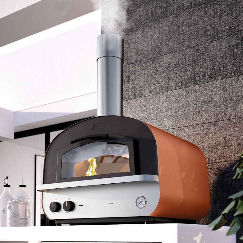 Fontana Piero Build In Gas & Wood Fired Pizza Oven, featuring a contemporary design with a chimney, is set against a textured wall and emits smoke gracefully from the top.