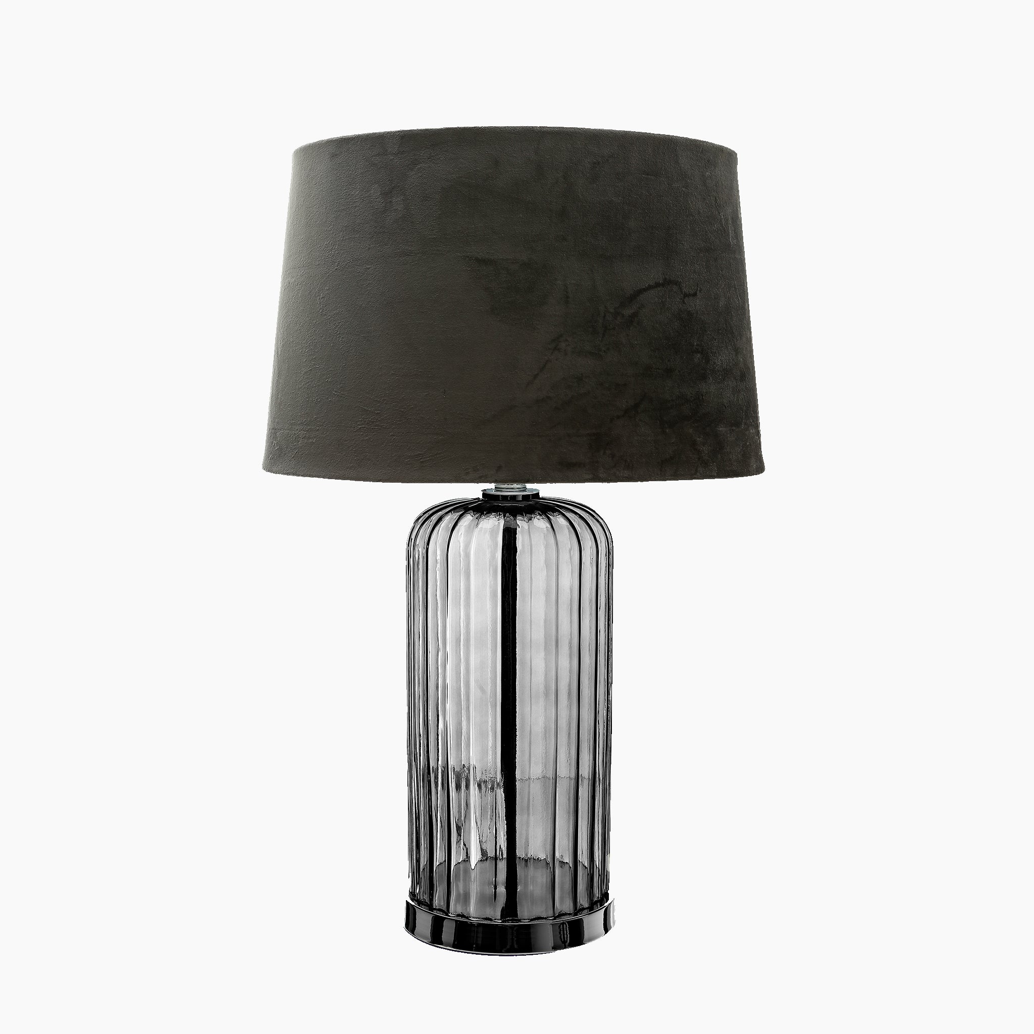 The Alberta Metallic Glass Lamp With Velvet Shade features a black cylindrical glass base paired with a dark green fabric lampshade, creating an elegant lighting option against a white background.