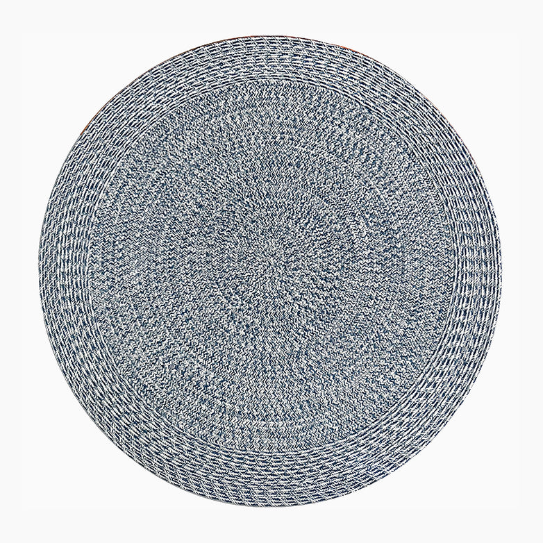 The Apollo 270cm Round Indoor and Outdoor Rug in Prussian Blue is a round woven rug featuring a blue and white braided pattern on a neutral Fog Grey background. Made from 100% polypropylene, it's both durable and stylish for any outdoor space.