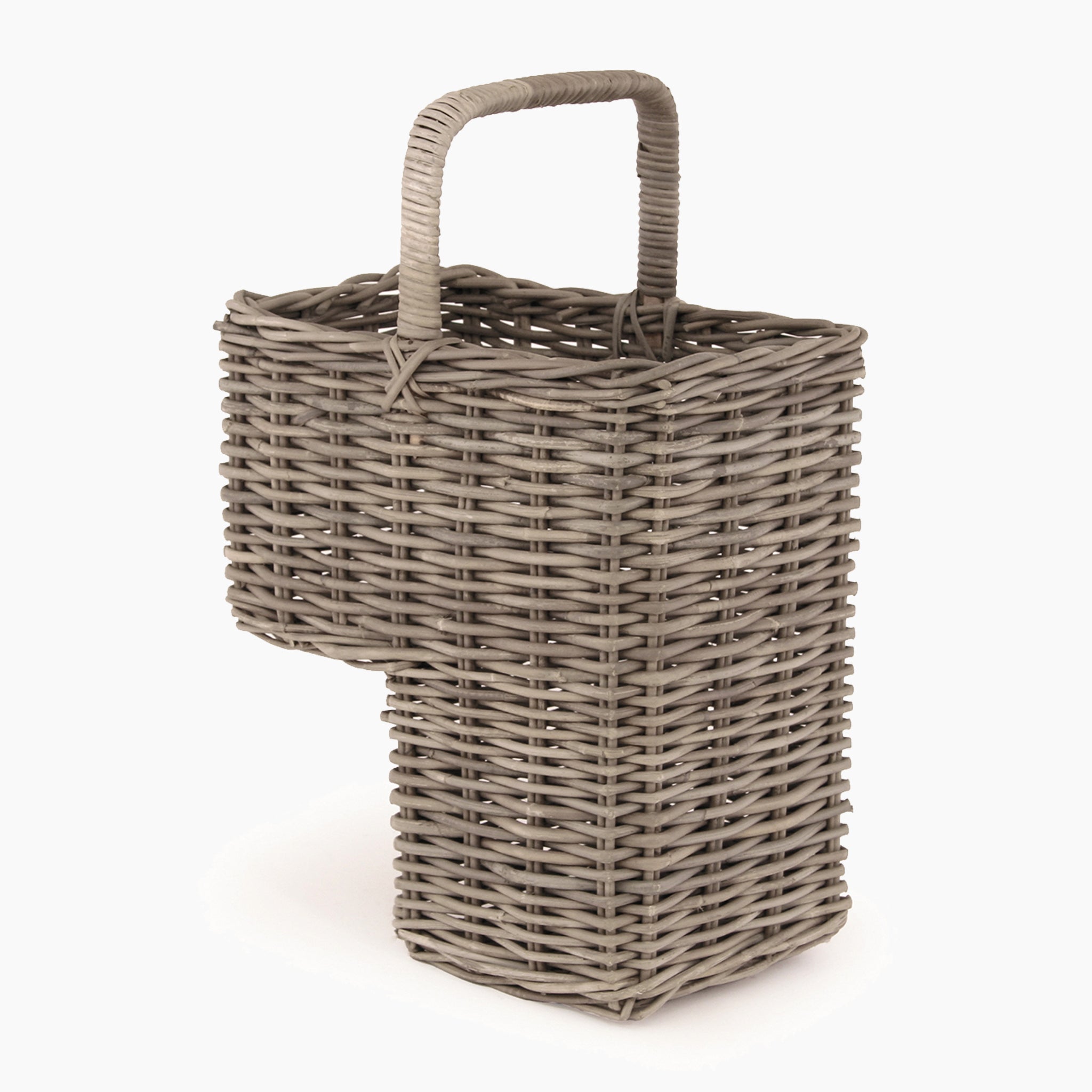 The Pacific Lifestyle Bali Grey Kubu Stair Basket is a handcrafted rectangular wicker basket with a central handle and a protruding lower section, ideal for those seeking charm and functionality.