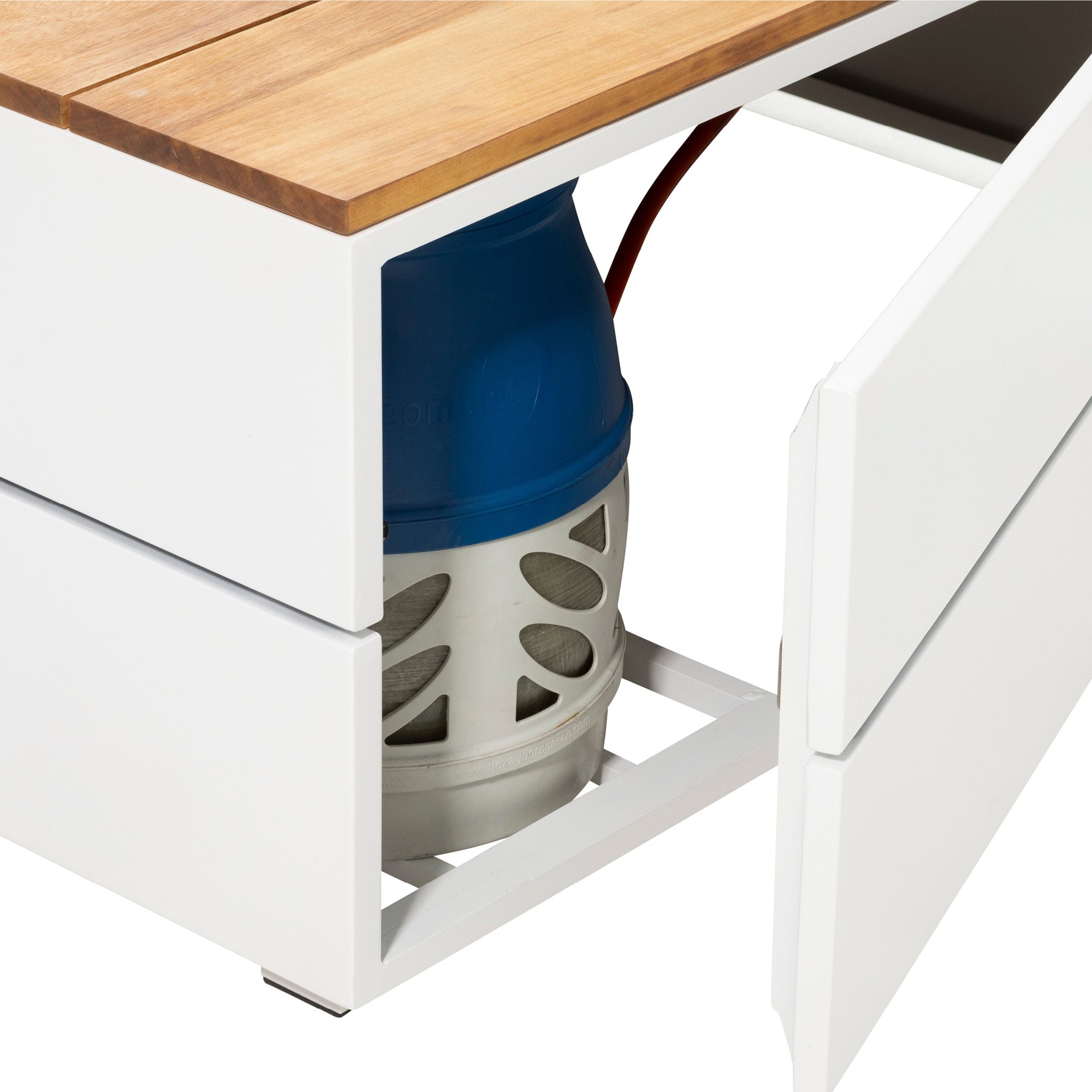 The Cosi - Cosipure 100 White and Teak Square Fire Pit cabinet opens to reveal a blue and white gas cylinder, ideal for powering your stylish fire pit table in a beautifully designed garden.