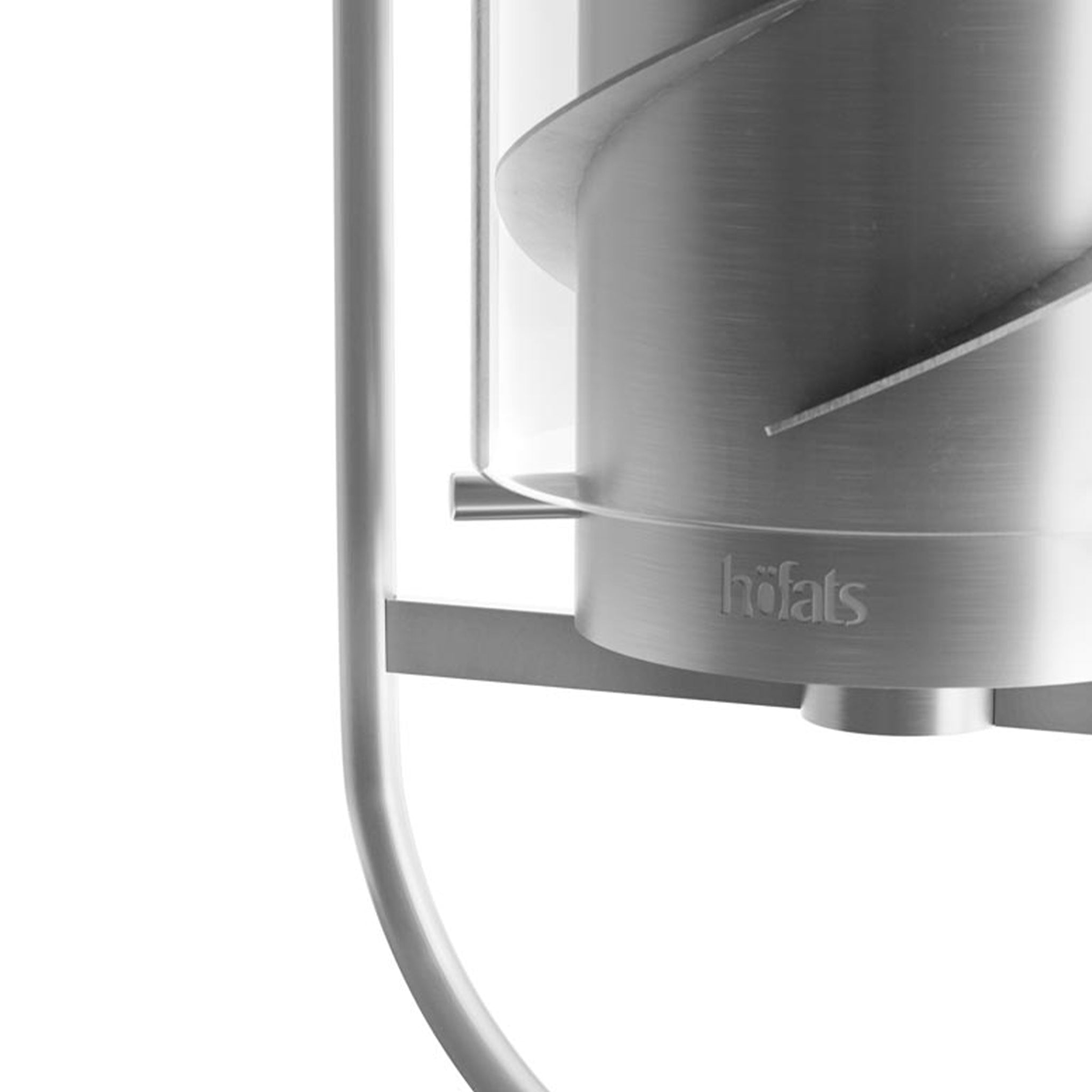 Close-up of an elegant, modern stainless steel candle holder with a curved design and "Höfats" branding visible, resembling the sleek aesthetics of the Höfats SPIN 120 Hanging Fire in Silver.